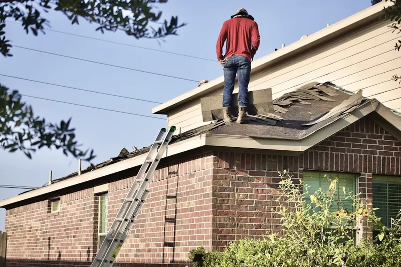 Professional roofer working on a residential roof in Cheswyck